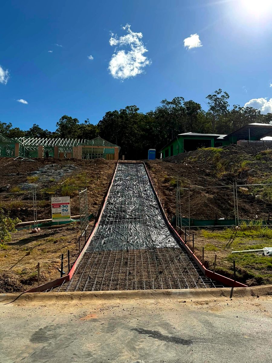 Steep driveway formed up with steel laid, before the pour